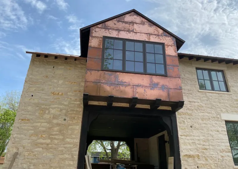 Copper metal panel facade on a stone building for Skylight Installation in Hawaiian Paradise Park
